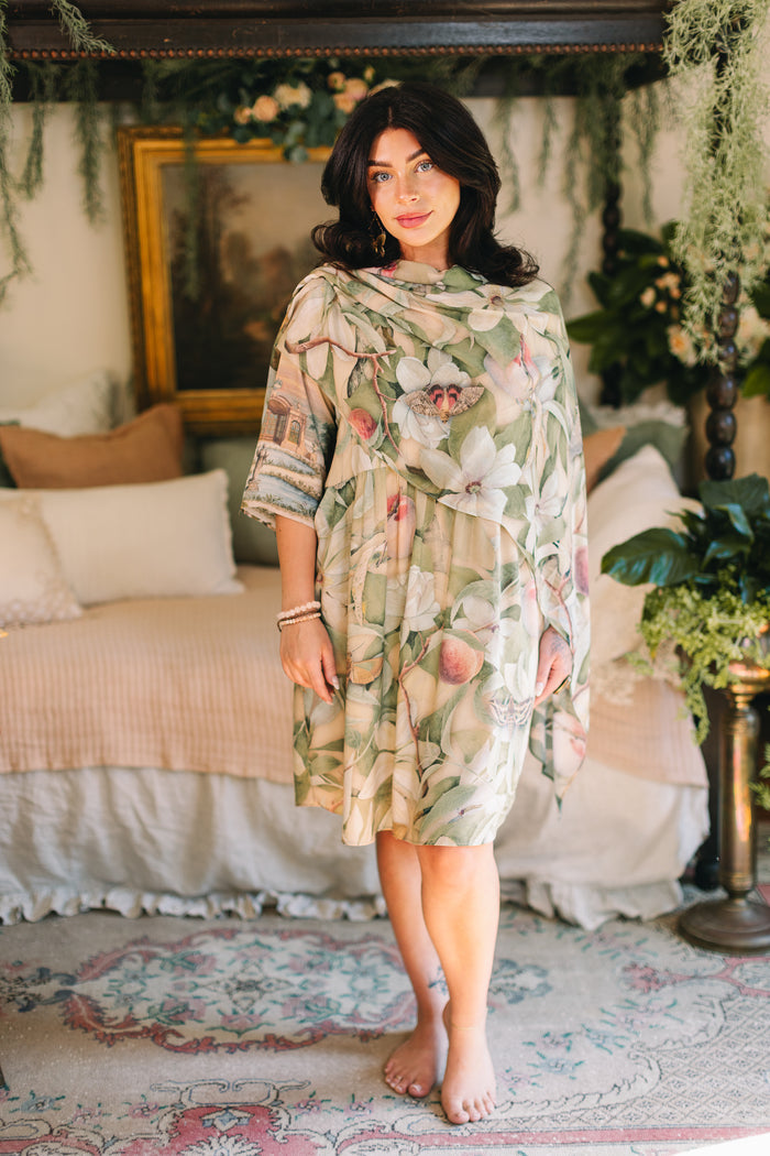 Model wearing a bamboo viscose scarf inspired by antique florals, butterflies, and sunlit gardens, this flowing duster captures the warmth and magic of golden hour - Market of Stars