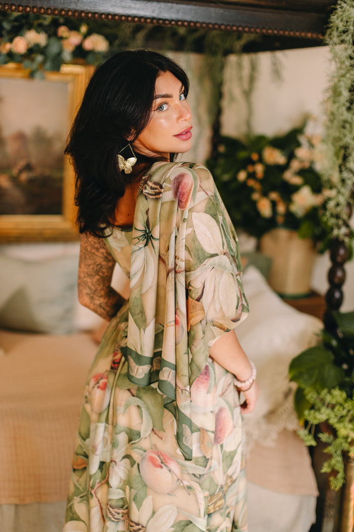 Model wearing a bamboo viscose scarf inspired by antique florals, butterflies, and sunlit gardens, this flowing duster captures the warmth and magic of golden hour - Market of Stars