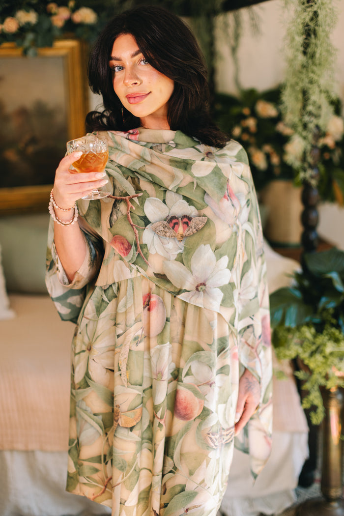Model wearing a bamboo viscose scarf inspired by antique florals, butterflies, and sunlit gardens, this flowing duster captures the warmth and magic of golden hour - Market of Stars