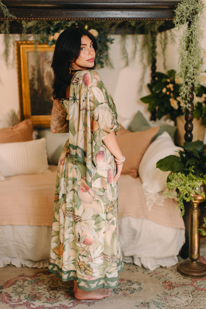 Model wearing a bamboo viscose scarf inspired by antique florals, butterflies, and sunlit gardens, this flowing duster captures the warmth and magic of golden hour - Market of Stars