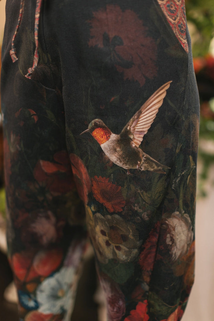 Model wearing the Folklore Artist Pant featuring the Bird-of-Peace embroidery and unfinished William Morris textile designs—artful linen blend pants by Market of Stars.