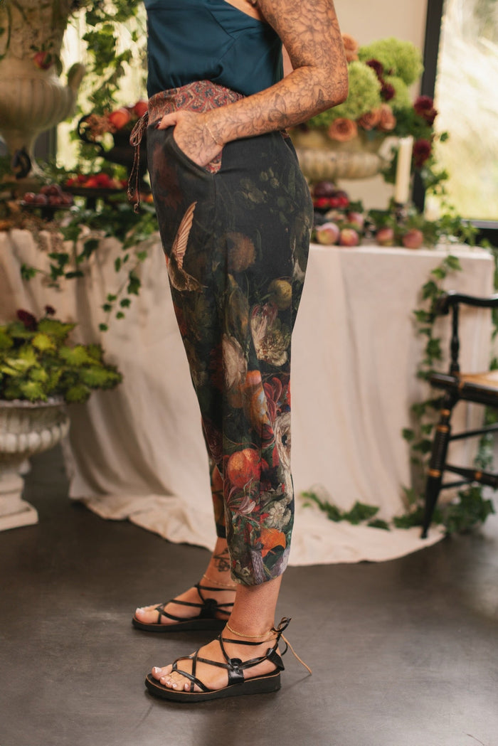 Model wearing the Folklore Artist Pant featuring the Bird-of-Peace embroidery and unfinished William Morris textile designs—artful linen blend pants by Market of Stars.