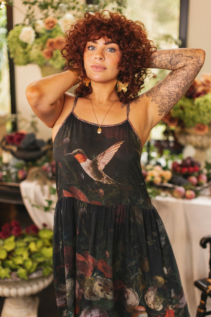 Model wearing Flight of Fancy Bohéme Slip Dress featuring hummingbirds and a vibrant floral bouquet inspired by 1700s still-life paintings by Rachel Ruysch – Market of Stars.