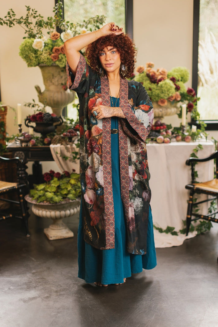 Model showcasing the Flight of Fancy Opera Robe featuring vibrant hummingbirds and historic floral paintings by Rachel Ruysch – Market of Stars.