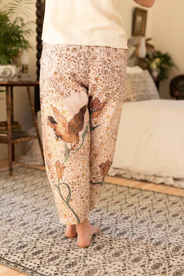 Model wearing Folklore Artist Pants featuring hand-stitched Bird-of-Peace embroidery and unfinished William Morris artwork celebrating the beauty of the artistic process – Market of Stars.