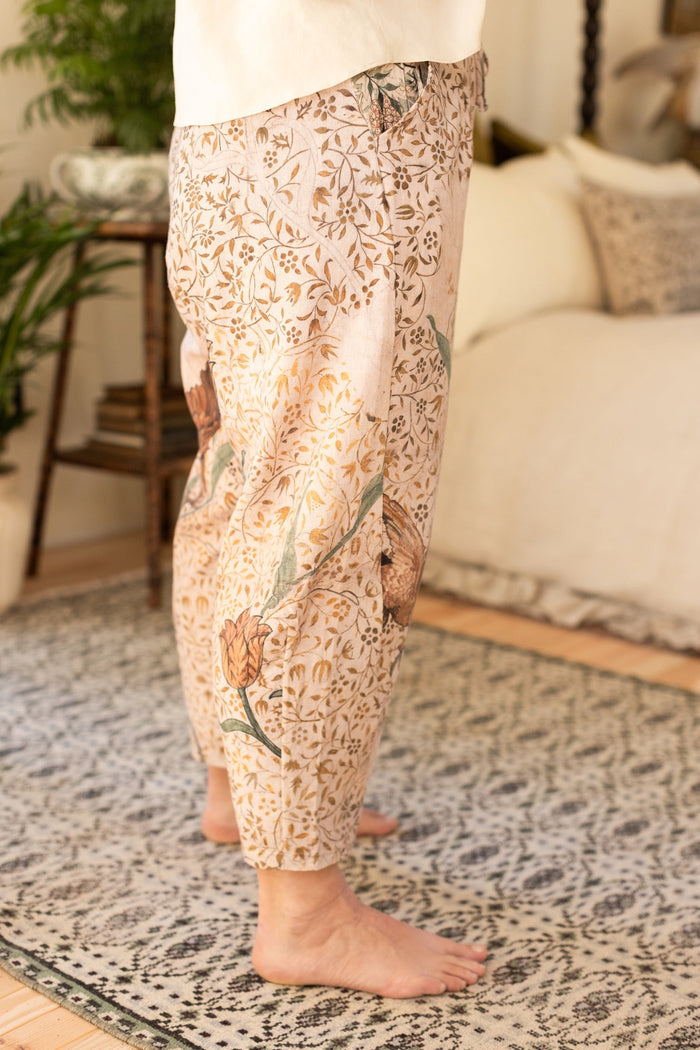 Model wearing Folklore Artist Pants featuring hand-stitched Bird-of-Peace embroidery and unfinished William Morris artwork celebrating the beauty of the artistic process – Market of Stars.