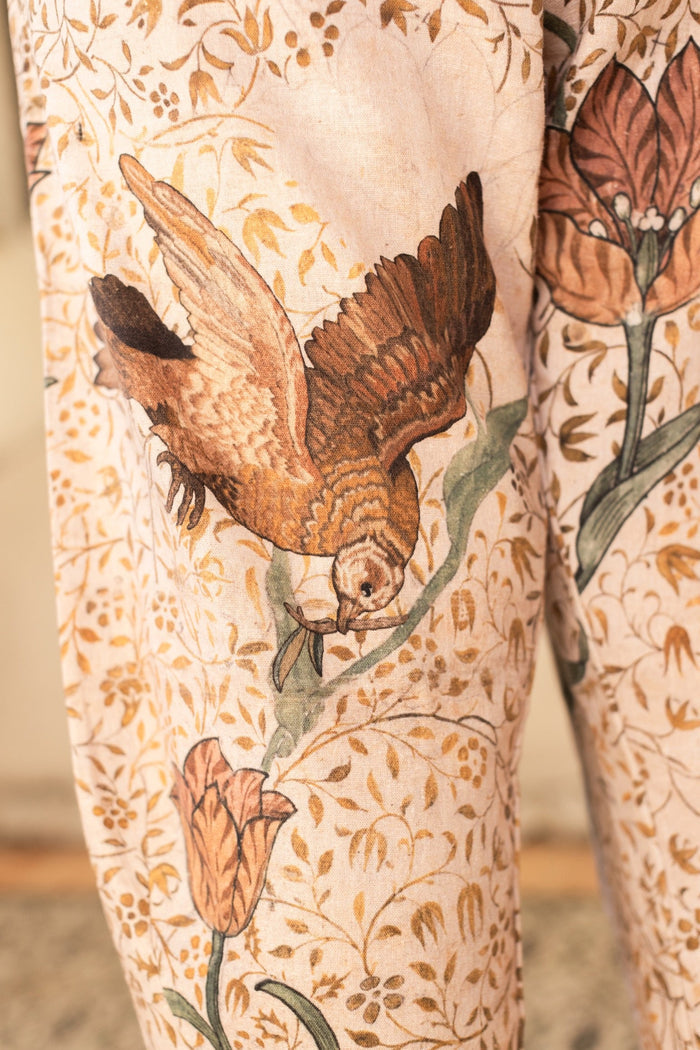 Model wearing Folklore Artist Pants featuring hand-stitched Bird-of-Peace embroidery and unfinished William Morris artwork celebrating the beauty of the artistic process – Market of Stars.