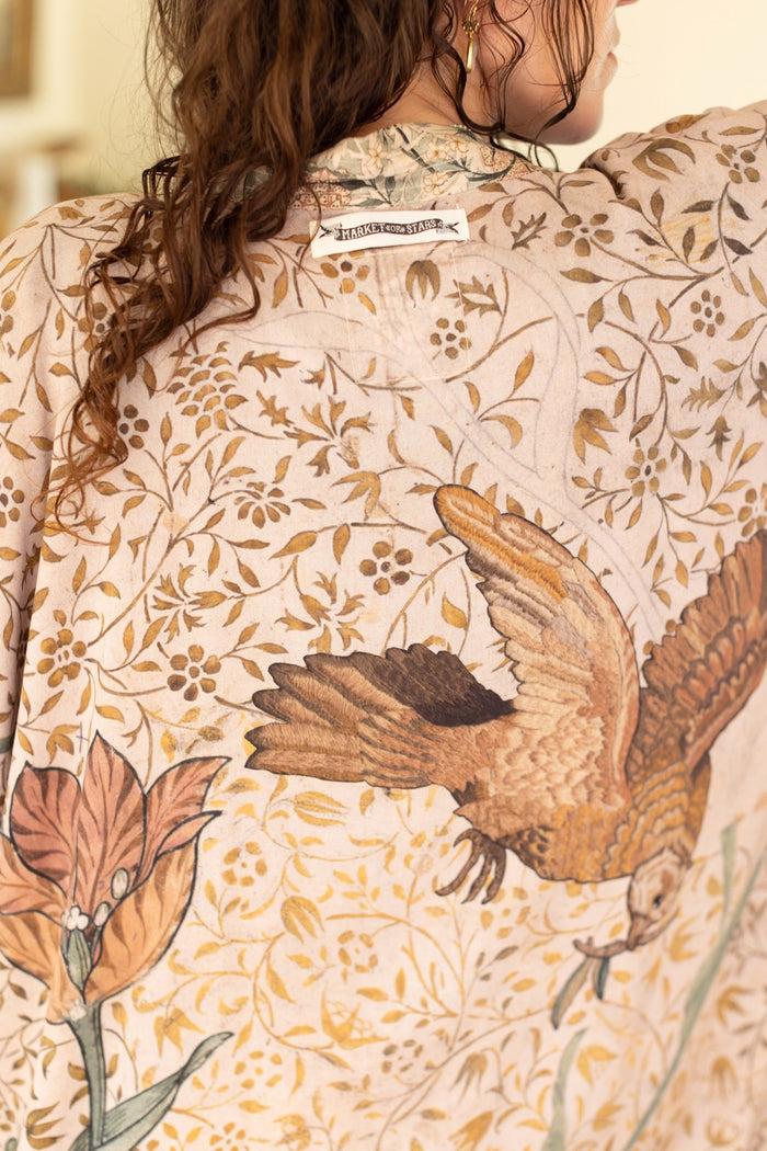 Model wearing opera-length kimono featuring the embroidered Bird-of-Peace by Kim Donohoe and unfinished William Morris panels celebrating artistic process – Market of Stars.