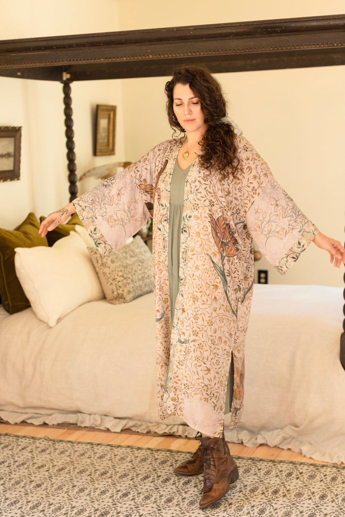 Model wearing opera-length kimono featuring the embroidered Bird-of-Peace by Kim Donohoe and unfinished William Morris panels celebrating artistic process – Market of Stars.