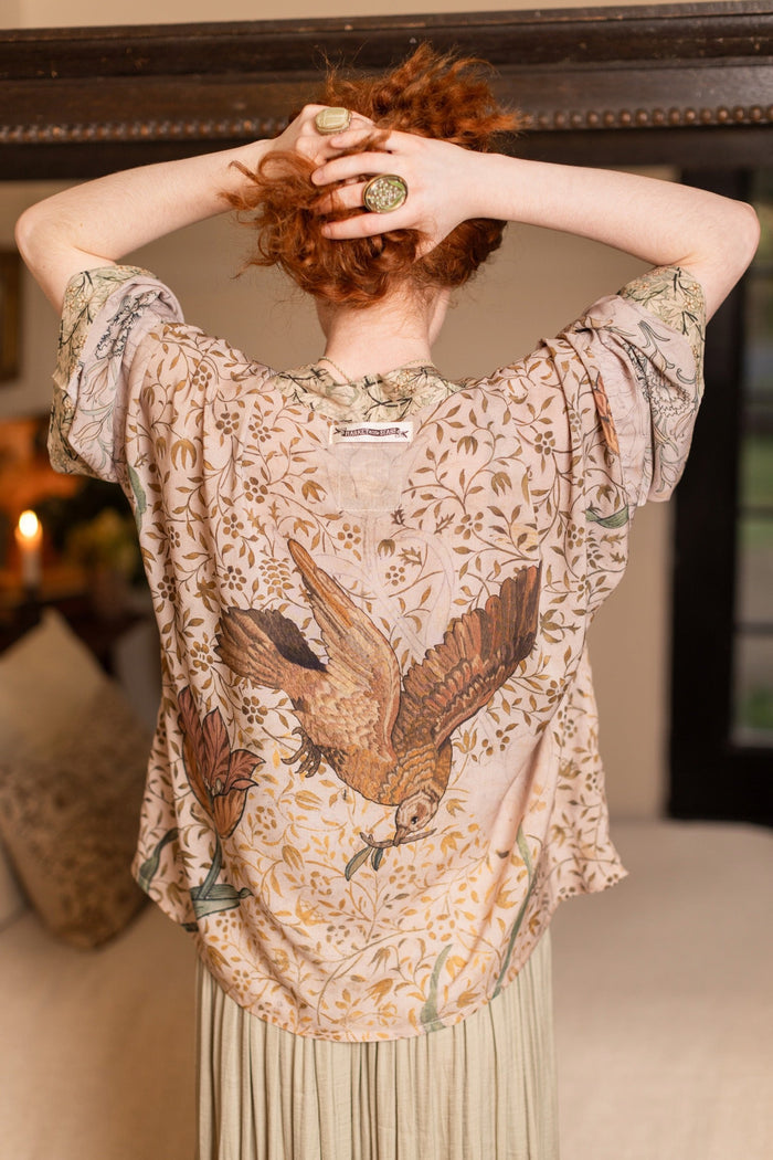 Model wearing full-length Folklore opera duster featuring Bird-of-Peace embroidery and unfinished William Morris textile panels in soft earthy tones – Market of Stars.