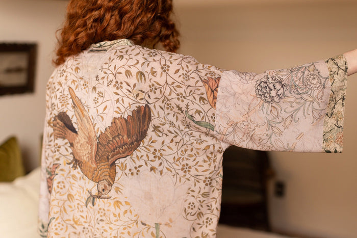 Model wearing full-length Folklore opera duster featuring Bird-of-Peace embroidery and unfinished William Morris textile panels in soft earthy tones – Market of Stars.