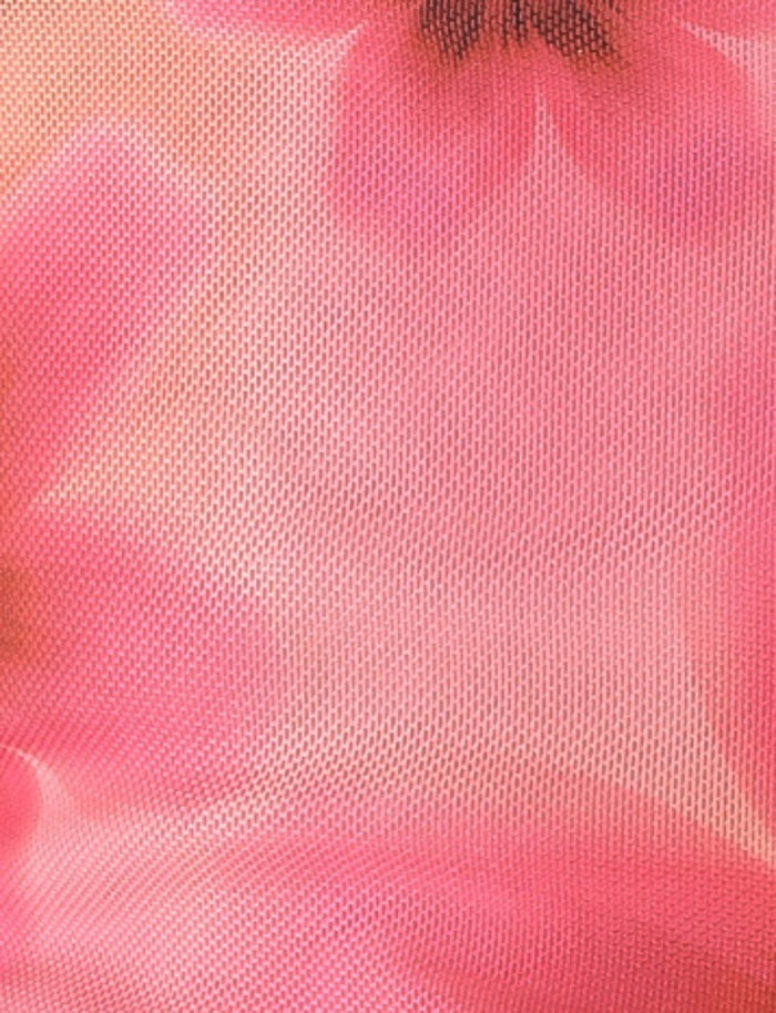 A close-up of the FRANCIS TOP - MULTI : OMBRE : FLORAL by TIGERMIST, showcasing a pink textured fabric with blurred floral prints in various shades of pink. The soft, feminine appearance and lightweight, airy texture suggest mesh fabrication, making it ideal for a floral print top.