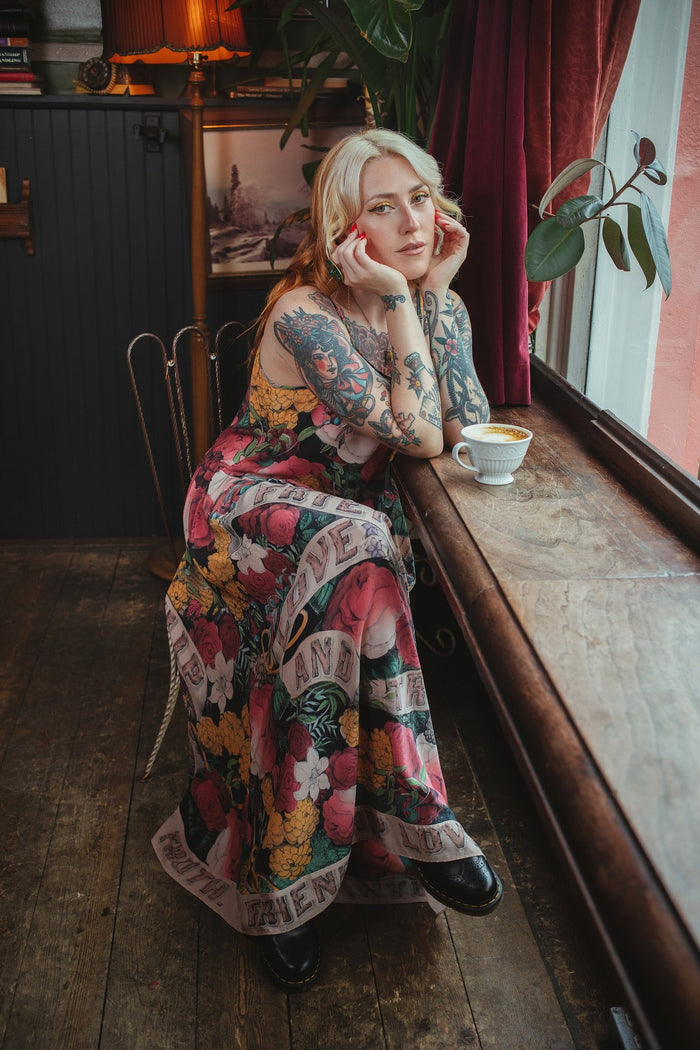 Model wearing reversible bamboo viscose slip dress featuring vintage symbols of friendship, love, and truth with pink and rose palette – Market of Stars.