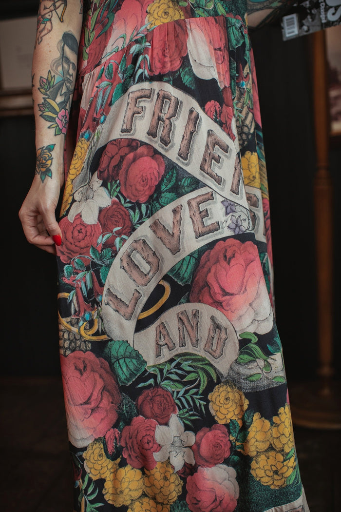 Model wearing reversible bamboo viscose slip dress featuring vintage symbols of friendship, love, and truth with pink and rose palette – Market of Stars.
