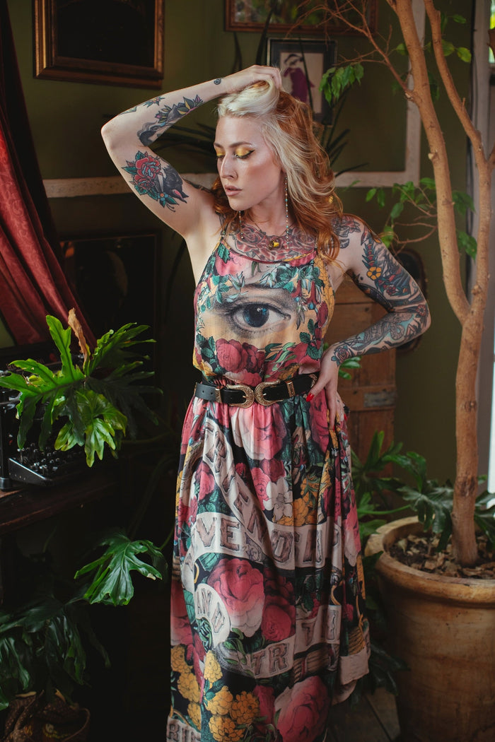 Model wearing reversible bamboo viscose slip dress featuring vintage symbols of friendship, love, and truth with pink and rose palette – Market of Stars.