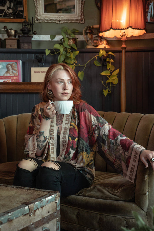 Model wearing our cropped kimono featuring historic symbols of friendship, love, and truth with archive-inspired wood-grain trim and romantic vintage details – Market of Stars.