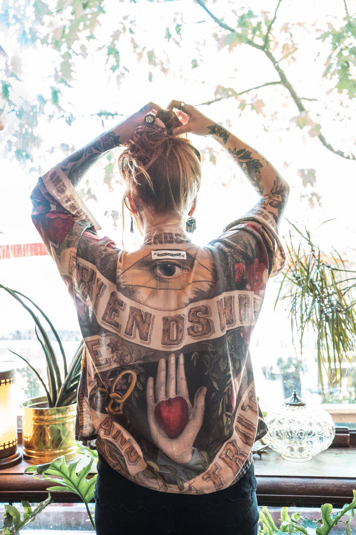 Model wearing our cropped kimono featuring historic symbols of friendship, love, and truth with archive-inspired wood-grain trim and romantic vintage details – Market of Stars.
