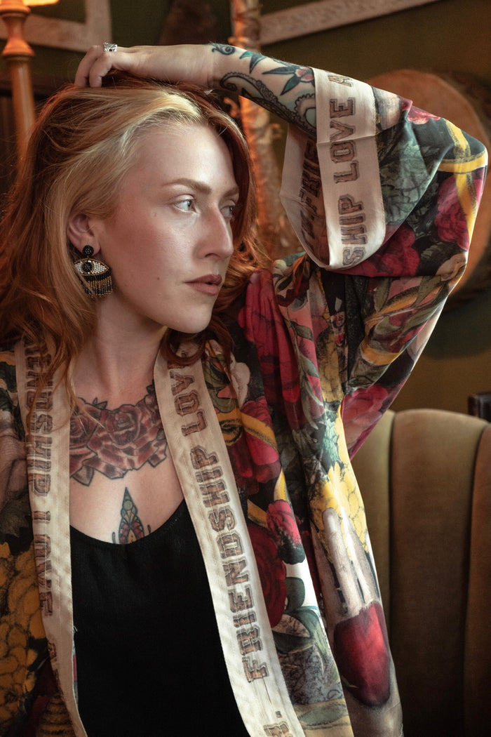 Model wearing our cropped kimono featuring historic symbols of friendship, love, and truth with archive-inspired wood-grain trim and romantic vintage details – Market of Stars.