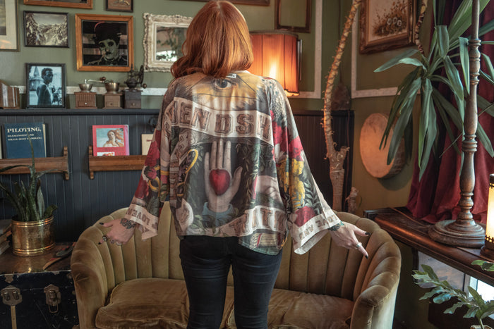 Model wearing our cropped kimono featuring historic symbols of friendship, love, and truth with archive-inspired wood-grain trim and romantic vintage details – Market of Stars.