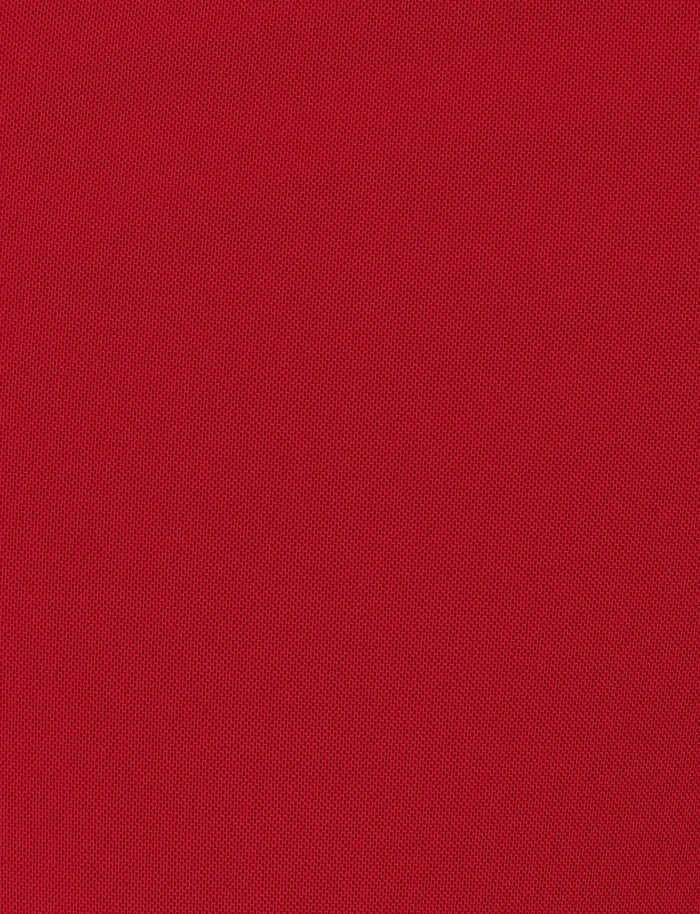 A close-up of a red textured, stretchy fabric with a fine mesh-like pattern. The fabric appears uniform with a consistent color and texture throughout the image, reminiscent of the material used in the popular TIGERMIST Ginny Maxi Skirt in Cherry Red.
