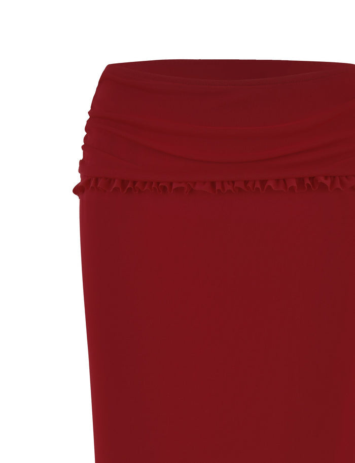 A close-up view of the TIGERMIST GINNY MAXI SKIRT - RED : CHERRY RED. The skirt, in a deep, vibrant red, features a ruched waistband with a subtle ruffle detail just below it and is crafted from smooth, stretchy fabric. The plain white background highlights the garment’s elegance.
