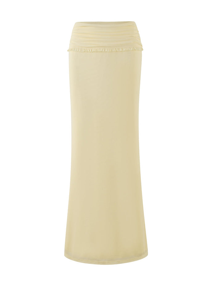 The GINNY MAXI SKIRT - YELLOW : LEMON by TIGERMIST is a maxi-length skirt in a light yellow hue that features a subtle ruffled detail on its wide waistband. Displayed against a white background, this piece boasts a smooth texture and falls straight, providing a sleek and elegant look.