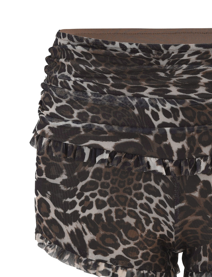 The GINNY SHORT - NEUTRAL : LEOPARD by TIGERMIST features a leopard print design with ruffle details along the waistband and hem, crafted from sheer fabric in shades of black, brown, and beige.