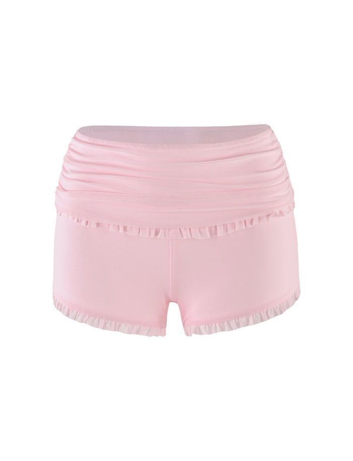 The GINNY SHORT - PINK by TIGERMIST is a pair of baby pink women's shorts featuring a wide waistband and ruffled trim along the top and leg openings. These shorts boast a fitted, bodycon silhouette with a soft, smooth texture.