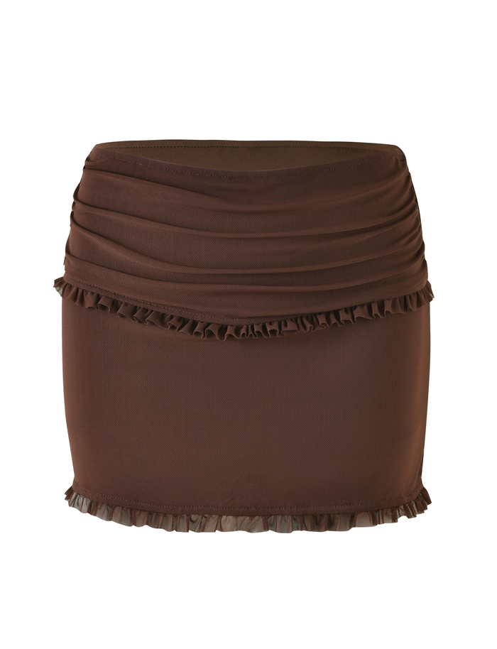The TIGERMIST GINNY SKORT - BROWN : CHOCOLATE is a brown mini skort with a fitted bodycon silhouette, ruched top detailing, and ruffle trim along the hem and upper section.