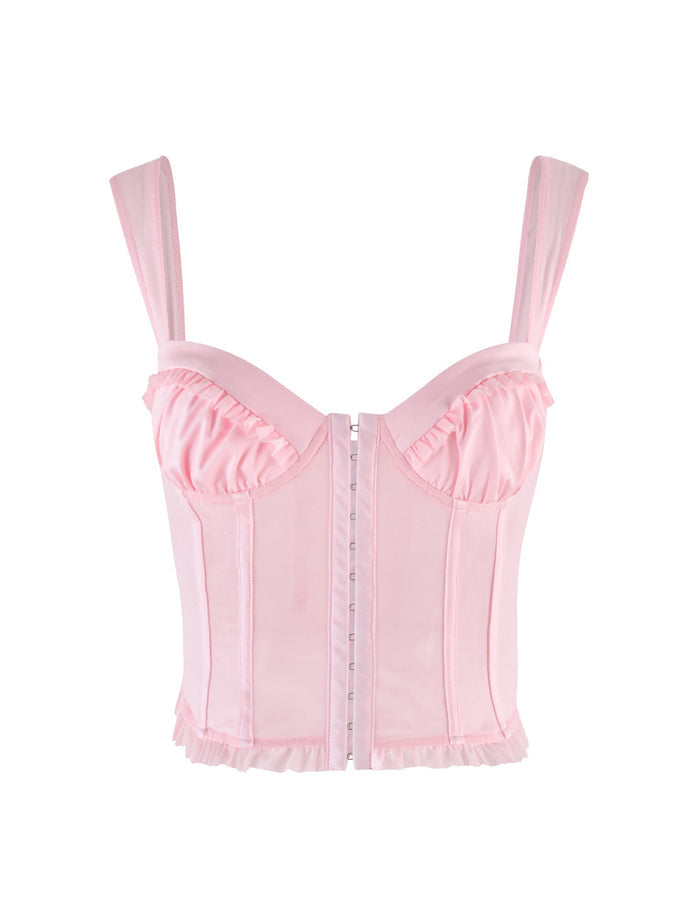 The TIGERMIST GINNY TOP - PINK features a baby pink corset-style design with wide straps, ruffled bust and hem, vertical seams, and a front hook-and-eye closure for a soft, feminine silhouette.