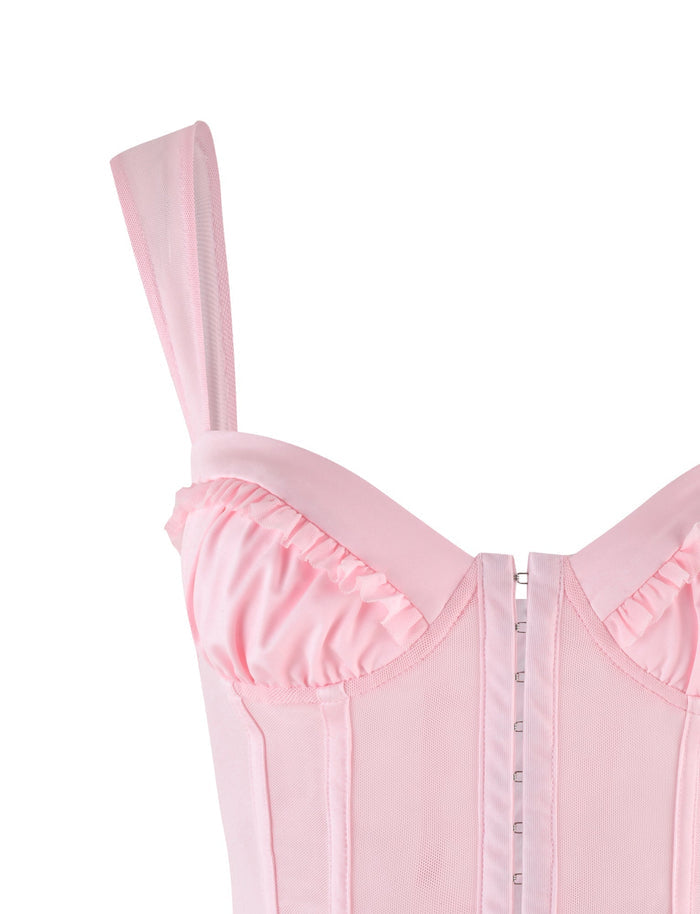 Close-up of the TIGERMIST GINNY TOP in baby pink, featuring wide straps, ruffled bust trim, structured boning, and a front hook-and-eye closure for a flattering bodycon fit.