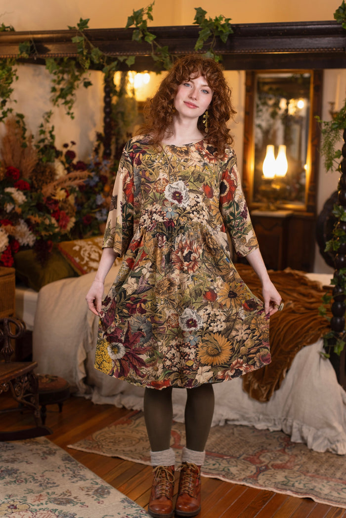 Model wearing a soft bamboo-viscose knee-length dress featuring rich 1700s botanical blooms and swallow trim - Market of Stars