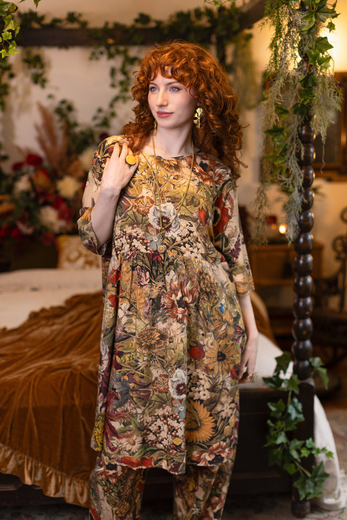 Model wearing a soft bamboo-viscose knee-length dress featuring rich 1700s botanical blooms and swallow trim - Market of Stars