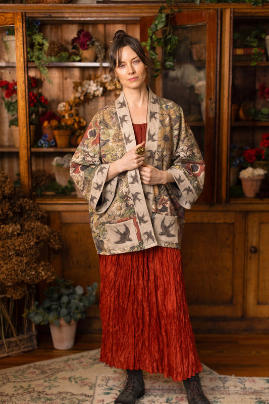 Model wearing a soft fleece cottage cardigan featuring rich 1700s botanical blooms and swallow trim - Market of Stars