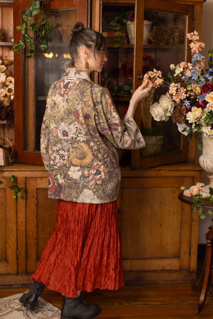 Model wearing a soft fleece cottage cardigan featuring rich 1700s botanical blooms and swallow trim - Market of Stars