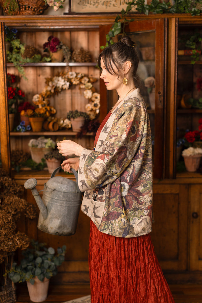 Model wearing a soft fleece cottage cardigan featuring rich 1700s botanical blooms and swallow trim - Market of Stars