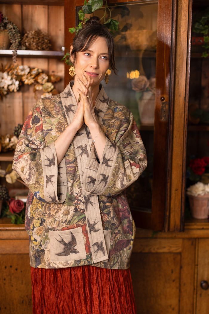 Model wearing a soft fleece cottage cardigan featuring rich 1700s botanical blooms and swallow trim - Market of Stars