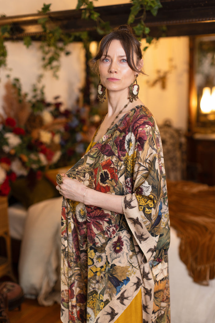 Model wearing a soft bamboo-viscose flowy duster featuring rich 1700s botanical blooms and swallow trim - Market of Stars