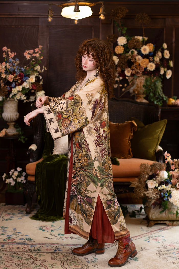 Model wearing a soft bamboo-viscose duster robe featuring rich 1700s botanical blooms and swallow trim - Market of Stars