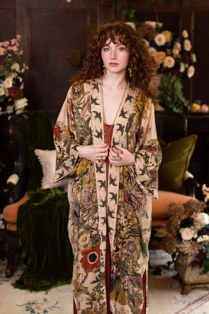 Model wearing a soft bamboo-viscose duster robe featuring rich 1700s botanical blooms and swallow trim - Market of Stars