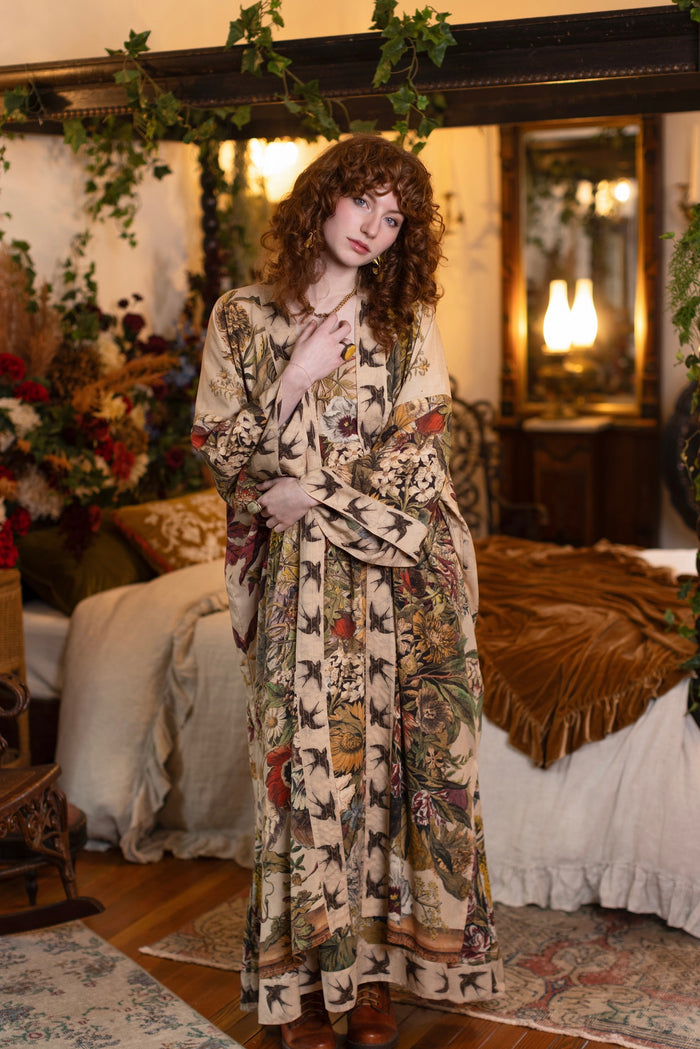Model wearing a soft bamboo-viscose duster robe featuring rich 1700s botanical blooms and swallow trim - Market of Stars