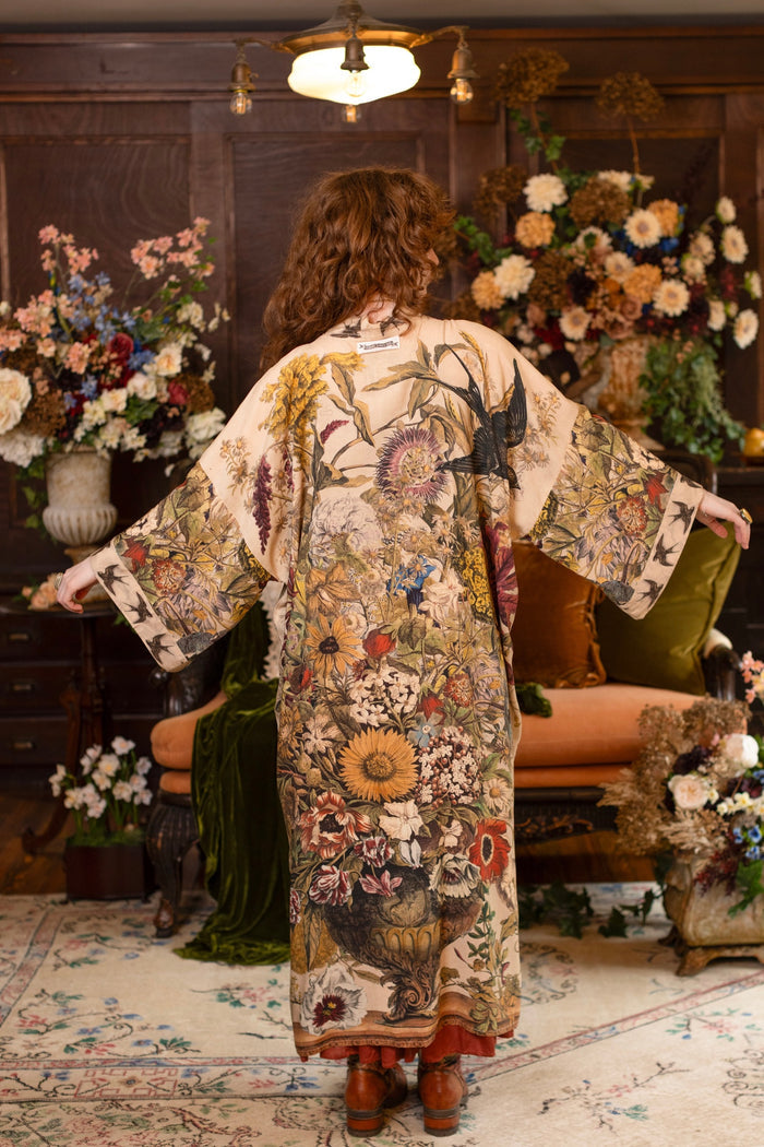 Model wearing a soft bamboo-viscose duster robe featuring rich 1700s botanical blooms and swallow trim - Market of Stars