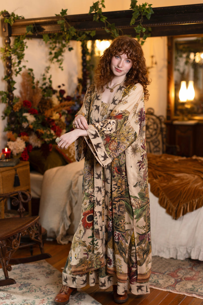 Model wearing a soft bamboo-viscose duster robe featuring rich 1700s botanical blooms and swallow trim - Market of Stars