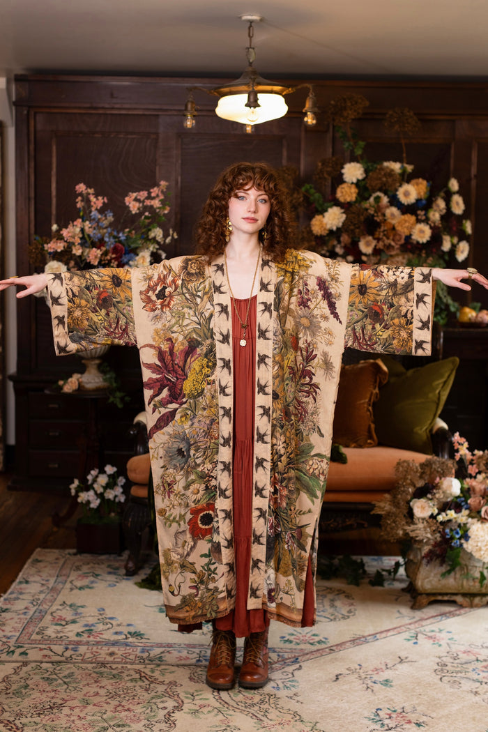 Model wearing a soft bamboo-viscose duster robe featuring rich 1700s botanical blooms and swallow trim - Market of Stars
