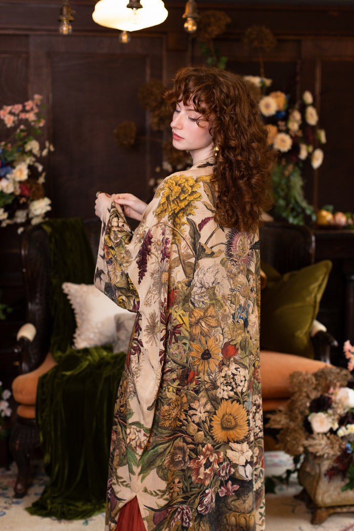 Model wearing a soft bamboo-viscose duster robe featuring rich 1700s botanical blooms and swallow trim - Market of Stars