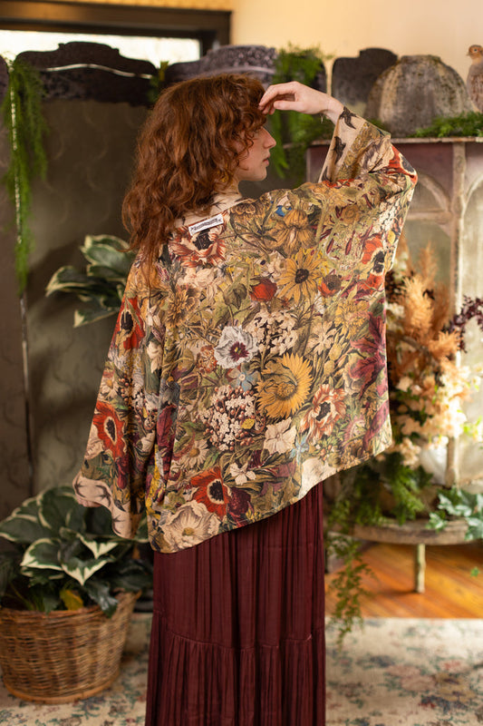 Model wearing a soft bamboo-viscose cropped duster featuring rich 1700s botanical blooms and swallow trim - Market of Stars