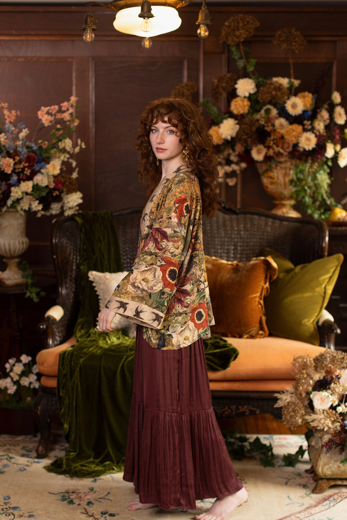 Model wearing a soft bamboo-viscose cropped duster featuring rich 1700s botanical blooms and swallow trim - Market of Stars