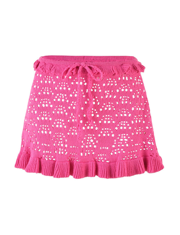 Introducing the GRAESON SKIRT by TIGERMIST in a vibrant hot pink. This mini skirt features a crochet fabrication with a drawstring waist and scalloped ruffled hem, creating an open-knit pattern for a textured and airy appearance.