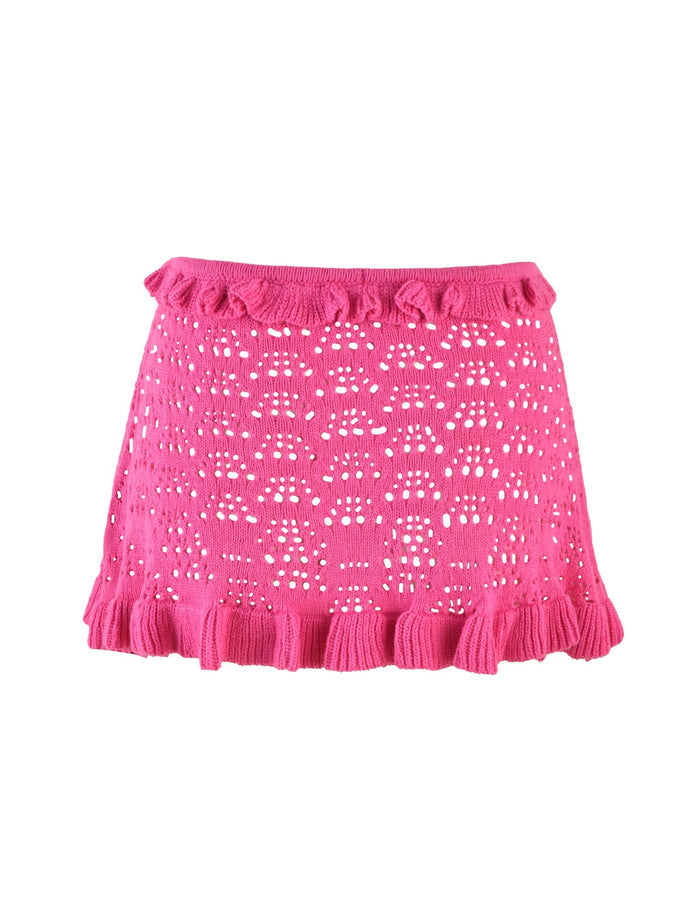Introducing the GRAESON SKIRT in HOT PINK by TIGERMIST—a vibrant mini skirt featuring a playful pattern of small cut-out holes. The unique texture of its crochet fabrication and the ruffled edges along the bottom hem and near the waistband make this skirt both fun and stylish. Crafted from soft, comfortable fabric, it’s perfect for adding a burst of color to your wardrobe.