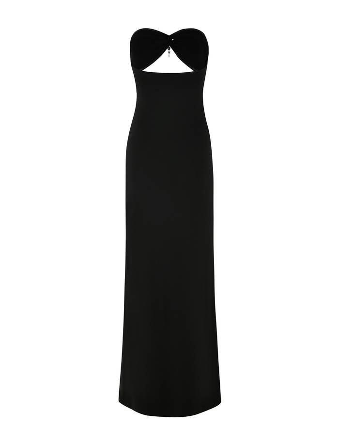 The GRAZIA DRESS - BLACK by TIGERMIST is a strapless, stretch maxi dress with a heart-shaped chest cutout, a silver jewel detail, and a sleek fitted silhouette that falls to the floor.